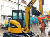 2023 Caterpillar 303.5 C CR mini excavator, rear three-quarter view