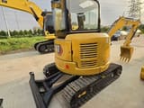 2024 Caterpillar 303.5E mini excavator rear three-quarter view