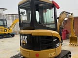 2023 Caterpillar 303CR mini excavator, rear three-quarter view