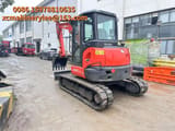 2023 Kubota KX057-4 mini excavator, front three-quarter view