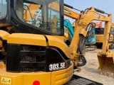 2024 Caterpillar 303.5E mini excavator, rear three-quarter view