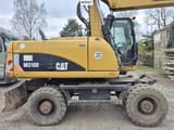 2010 Caterpillar M318D wheel excavator side view
