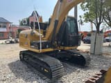 2021 Caterpillar 312D excavator, rear three-quarter view
