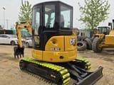 2023 Caterpillar 303.5E2 mini excavator, rear three-quarter view