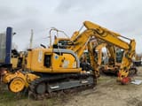2006 New Holland E135SR-1ES crawler excavator, rear three-quarter view