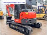 2023 Kubota KX057-4 mini excavator, front three-quarter view
