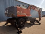 1999 O&K MH 5 wheel excavator, rear three-quarter view