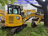2024 Caterpillar 303.5E mini excavator, rear three-quarter view