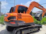 2024 Doosan DX75-9C mini excavator, rear three-quarter view