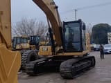 2021 Caterpillar 320 excavator, front three-quarter view