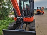 Kubota KX163-5 mini excavator, front view with blade