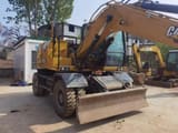 2023 Caterpillar M315GC wheel excavator, front three-quarter view