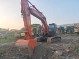 Hitachi ZX210 crawler excavator, front three-quarter view