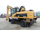 2008 Caterpillar M322D material handler, rear three-quarter view