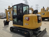 2023 Caterpillar 305.5E mini excavator, rear three-quarter view
