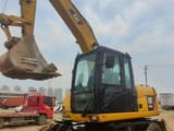 2023 Caterpillar 315D wheel excavator, front three-quarter view