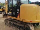 2023 Caterpillar 307E2 mini excavator, rear three-quarter view