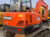 2024 Doosan DH55 mini excavator, rear three-quarter view