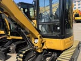 2024 Caterpillar 303.5 mini excavator, front three-quarter view
