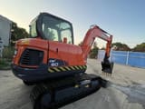 2022 Doosan DX60 mini excavator, rear three-quarter view