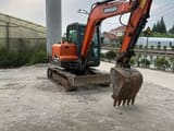 2018 Doosan DX55 mini excavator, front three-quarter view
