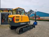 2025 Hyundai HX60PRO mini excavator, rear three-quarter view