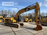 2011 Caterpillar 323DL crawler excavator side view