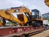 2016 Caterpillar 325D crawler excavator, side profile view on flatbed trailer