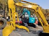 2024 Komatsu PC55 crawler excavator, side view of boom and thumb attachment