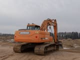 Doosan DX225LC crawler excavator, rear three-quarter view