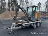 2019 Volvo EC18E crawler excavator on a trailer, side view