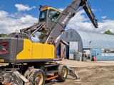 2018 Volvo EW240EMH material handler, rear three-quarter view