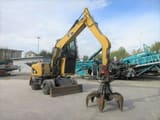 2009 Caterpillar M313D material handler, side view