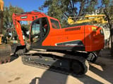2022 Doosan DX225LC-9C excavator, rear three-quarter view
