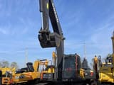 2025 Volvo EC240 crawler excavator, front view with raised boom