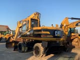 2000 Caterpillar M315 wheel excavator rear three-quarter view