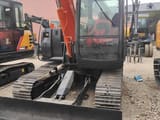 Hitachi ZX70 crawler excavator, front view with blade