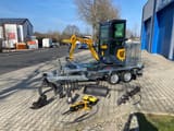 Berger Kraus BK950KS mini excavator on trailer with attachments
