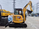 2023 Caterpillar 303.5E mini excavator, rear three-quarter view