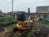 2021 Caterpillar 303.5 mini excavator, rear three-quarter view
