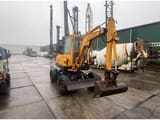 1990 Komatsu PW30-1 wheel excavator, front three-quarter view
