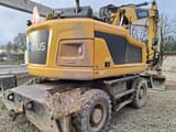 2021 Caterpillar M315F wheel excavator, rear three-quarter view