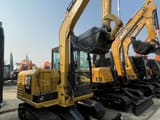2024 Caterpillar 305.5E2 mini excavator, rear three-quarter view