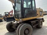 2018 Caterpillar M315D wheel excavator, front three-quarter view