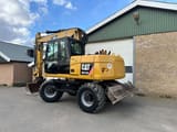 2011 Caterpillar M313D wheel excavator, rear three-quarter view