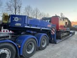 2012 Caterpillar 320E crawler excavator loaded on a flatbed trailer