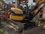 2023 Caterpillar 304 CR mini excavator, rear three-quarter view