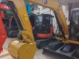 2024 Caterpillar 305.5E2 mini excavator, front three-quarter view