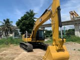 2025 Caterpillar 323D3 crawler excavator, front three-quarter view