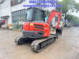2023 Kubota KX057-4 mini excavator, rear three-quarter view
